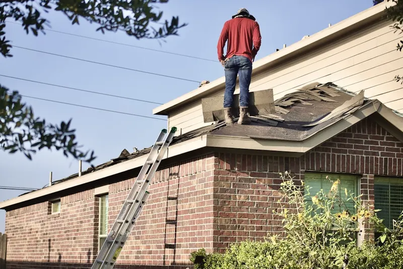 Professional roofer working on a residential roof in Riverway Estates-Bruton Terrace